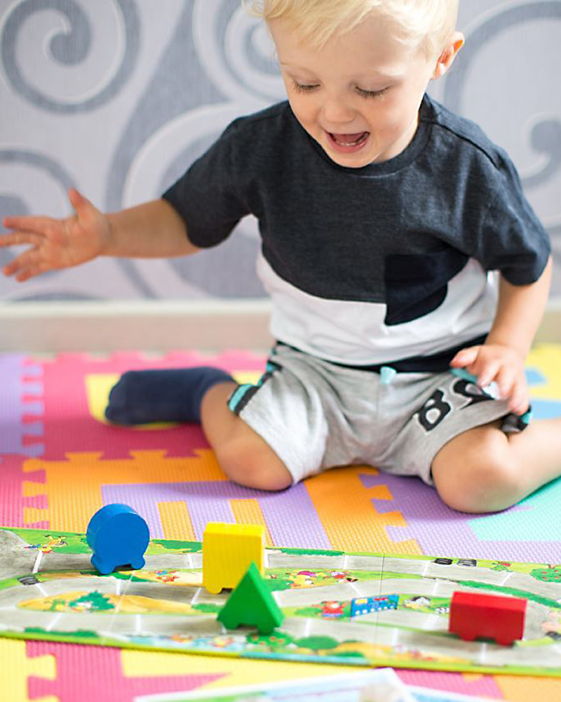 Un enfant avec des jouets en bois colorés d'Autorelli par Selecta