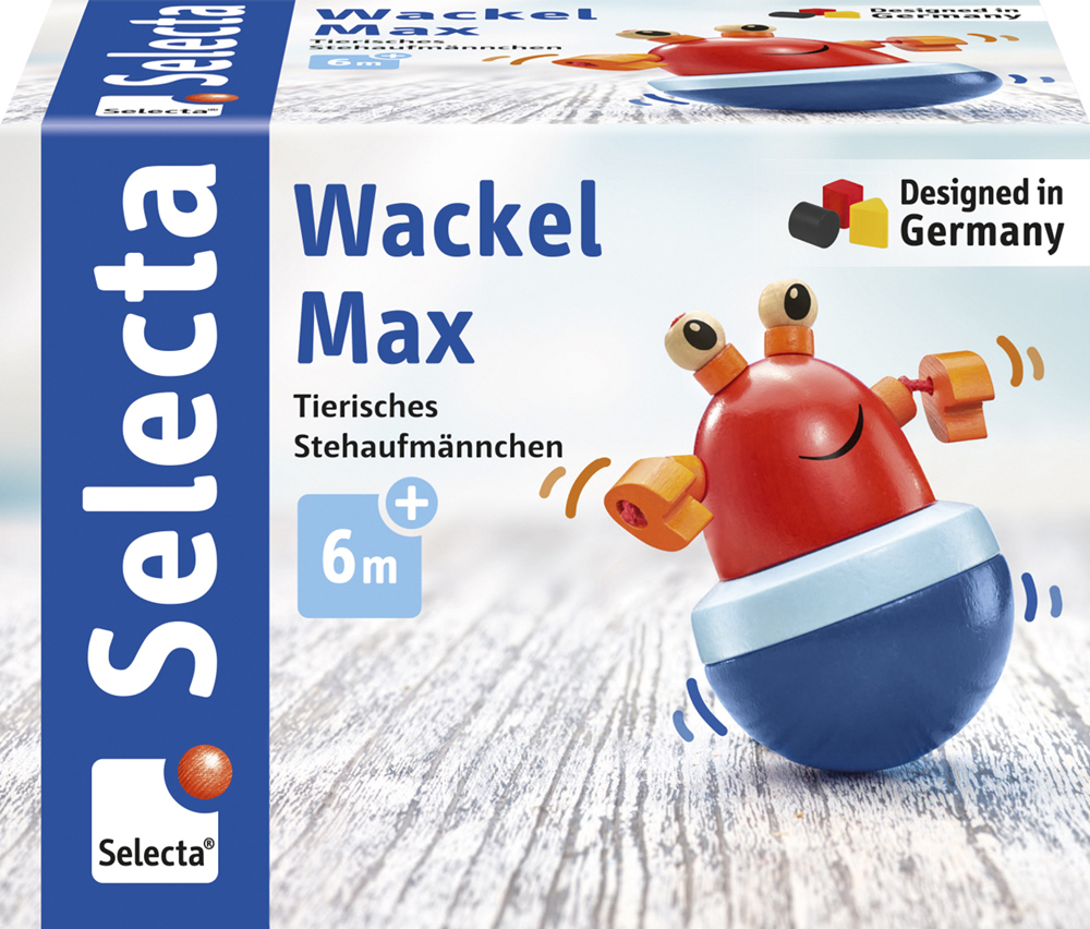 Jouet « Max » rouge et bleu dont les yeux clignotent, présenté dans une boîte « Wackel Max », à partir de 6 mois, de la marque Selecta.